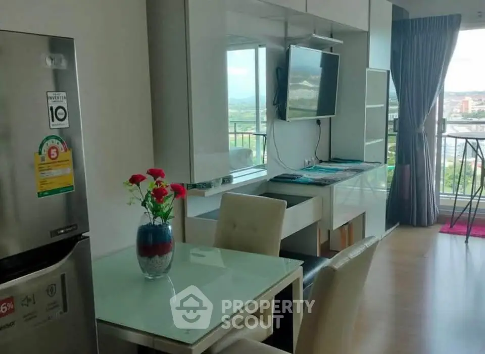 Modern living room with dining area and balcony view