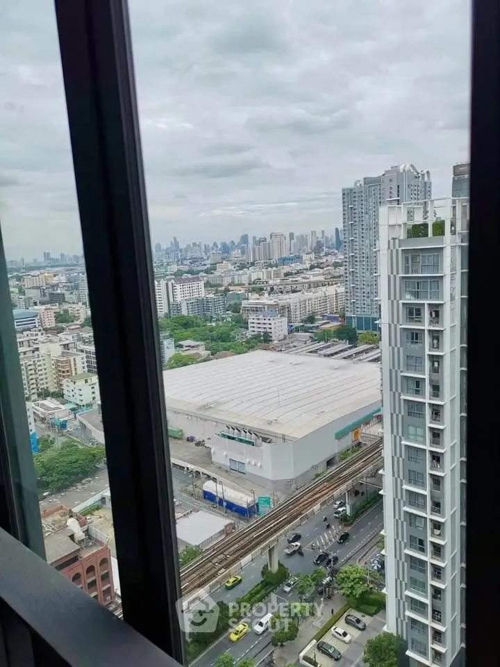 Stunning cityscape view from high-rise apartment window showcasing urban skyline and bustling streets.