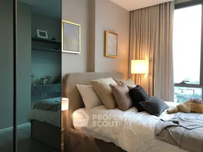 Luxurious bedroom with elegant decor and large window offering stunning city views.