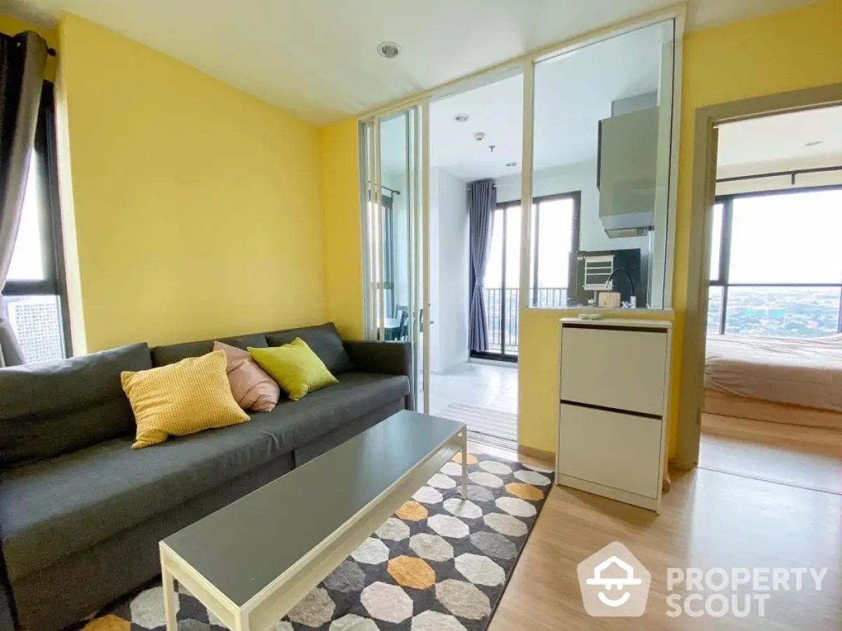 Modern living room with vibrant yellow walls and city view, featuring cozy sofa and stylish decor.