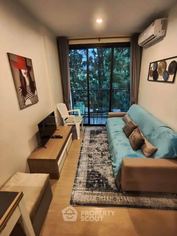 Cozy living room with modern decor and balcony view in a stylish apartment.