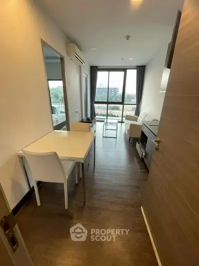 Modern living room with large window and stylish furniture in a cozy apartment.