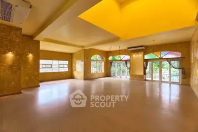 Spacious and vibrant living room with colorful windows and ample natural light.