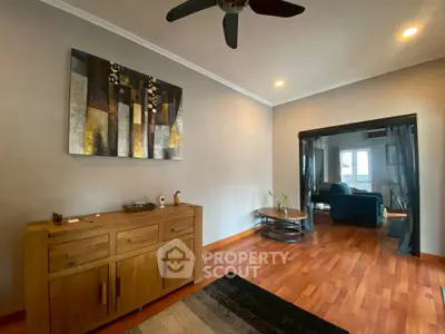 Spacious living room with modern decor and wooden flooring