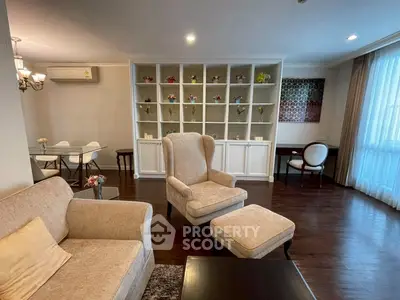 Elegant living room with cozy seating and stylish decor in a modern apartment.