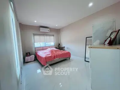 Spacious bedroom with modern decor and natural light