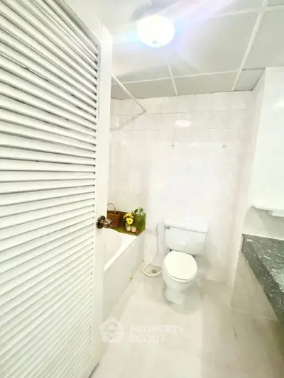 Bright and clean bathroom with bathtub and modern fixtures in a stylish home.