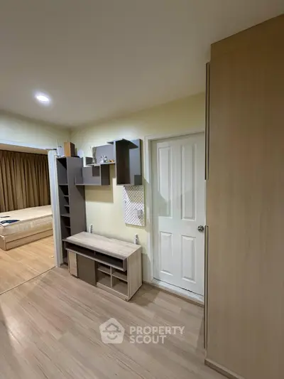 Modern bedroom with wooden flooring and built-in storage solutions