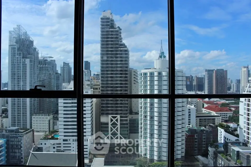Stunning cityscape view from high-rise building window showcasing modern urban skyline.