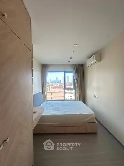 Modern bedroom with city view, featuring minimalist design and natural light.