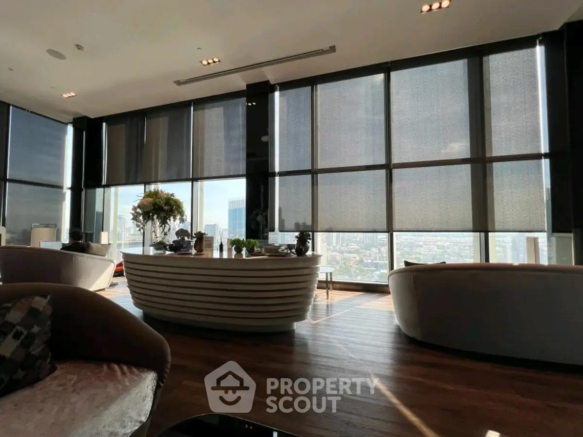 Luxurious high-rise living room with panoramic city views and modern decor.