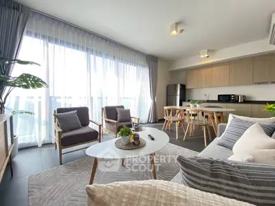 Modern open-plan living room with stylish furniture and large windows