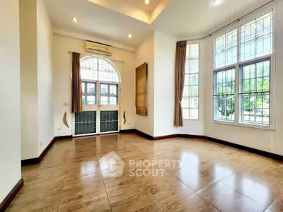 Spacious bright room with large windows and elegant tile flooring