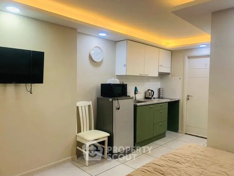 Cozy studio apartment with modern kitchenette and ambient lighting