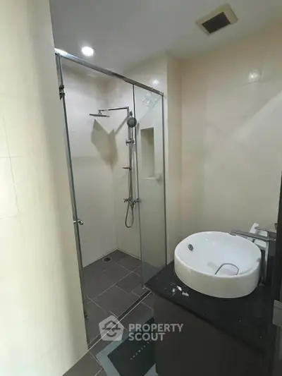 Modern bathroom with glass shower enclosure and sleek sink design