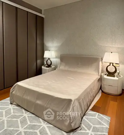 Luxurious bedroom with elegant decor and modern furnishings, featuring a stylish bed and ambient lighting.