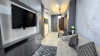 Modern living room with sleek design, featuring a wall-mounted TV, stylish sofa, and elegant decor.