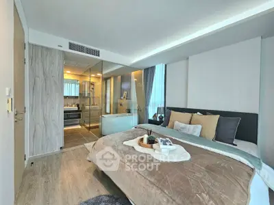 Luxurious bedroom with ensuite bathroom featuring modern design and cozy decor.