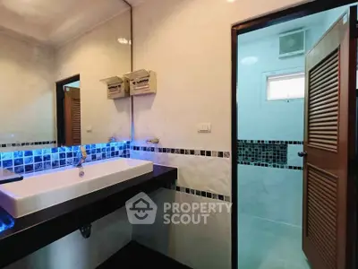 Modern bathroom with stylish sink and ambient lighting