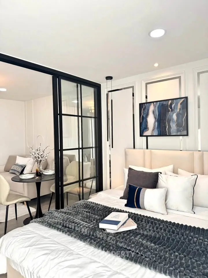 Modern bedroom with stylish decor and cozy seating area, perfect for relaxation.