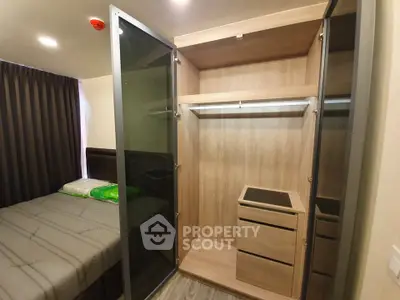 Modern bedroom with open wardrobe showcasing ample storage space.