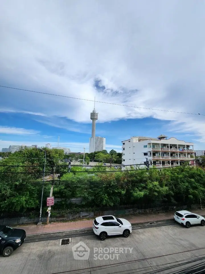 Scenic city view with prominent tower and residential buildings