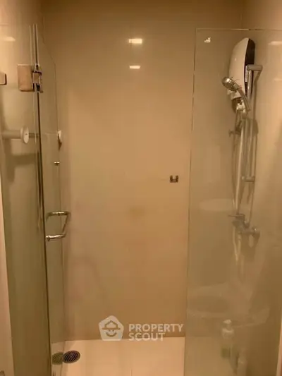 Modern bathroom with glass shower enclosure and sleek fixtures