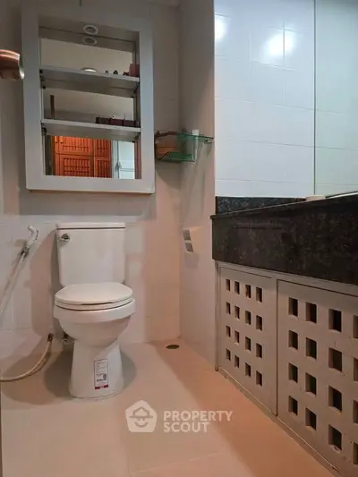 Modern bathroom with sleek fixtures and ample storage space.