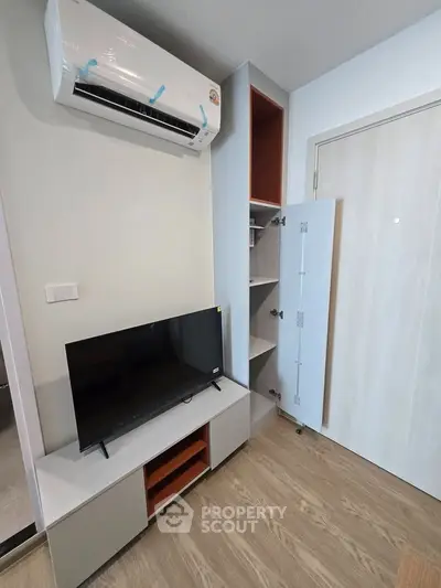 Modern living room with air conditioning and sleek TV setup
