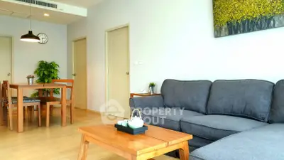 Spacious living room with cozy sofa and dining area in modern apartment