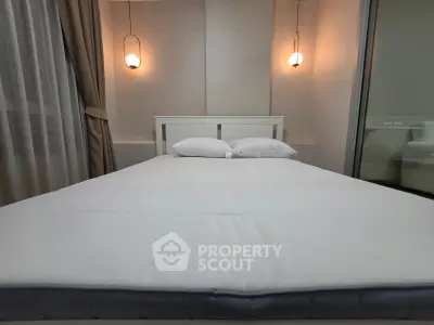 Cozy bedroom with modern lighting and elegant decor, perfect for relaxation and comfort.