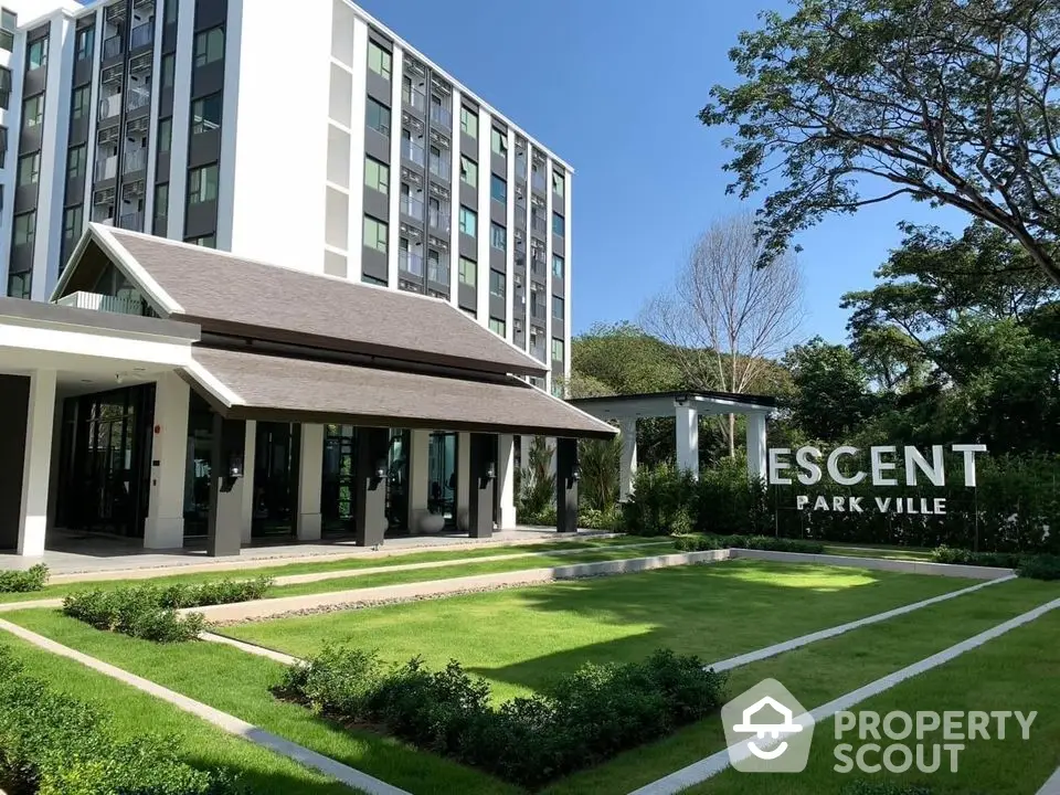 Modern residential building with lush green garden at Escent Park Ville