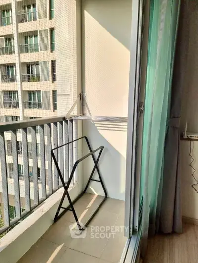 Charming balcony with drying rack and city view, perfect for urban living.