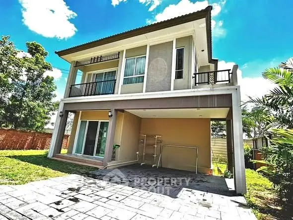 Modern two-story house with spacious balcony and lush garden