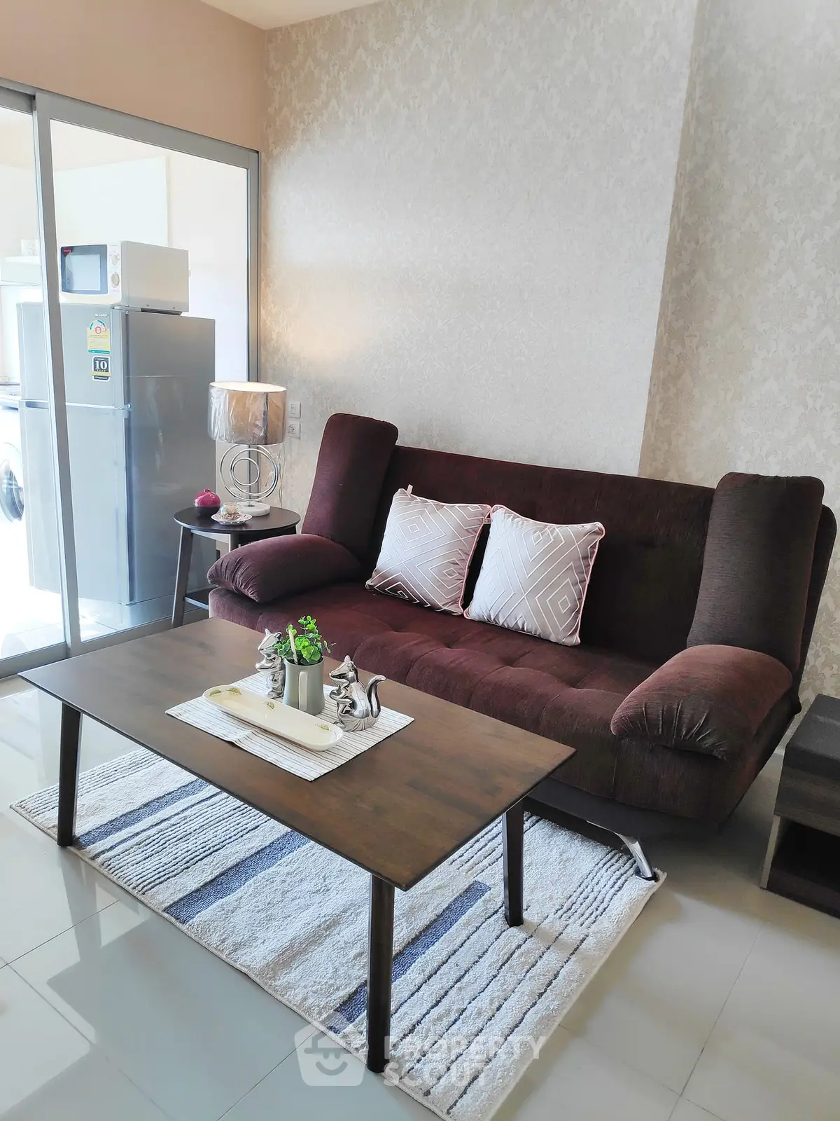 Cozy living room with modern decor and natural light, featuring a plush sofa and stylish coffee table.
