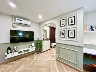 Modern living room with stylish decor and wall-mounted TV