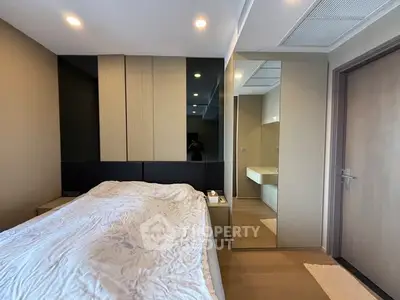Modern bedroom with stylish mirrored wardrobe and cozy lighting