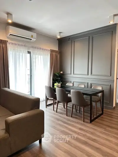 Elegant living room with modern dining area and natural light