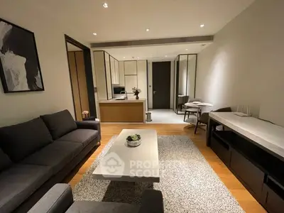 Modern living room with stylish furniture and open kitchen layout, perfect for contemporary living.