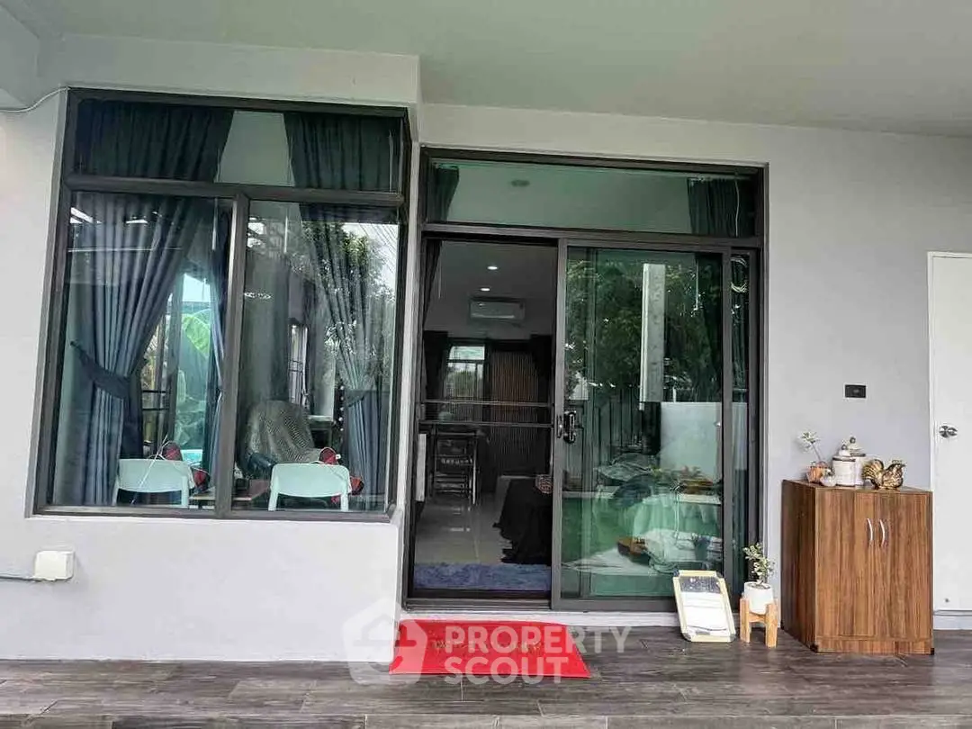 Modern home entrance with glass doors and cozy interior view