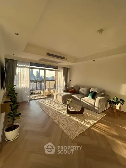 Spacious living room with elegant decor and city view balcony, perfect for modern urban living.