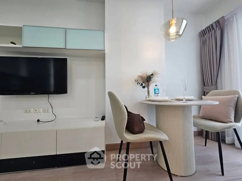 Modern dining area with stylish chairs and elegant lighting in a contemporary apartment.