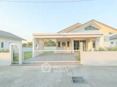 Modern single-story house with spacious driveway and minimalist design.