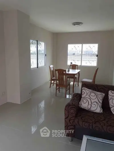 Bright living room with modern furniture and large windows offering natural light.
