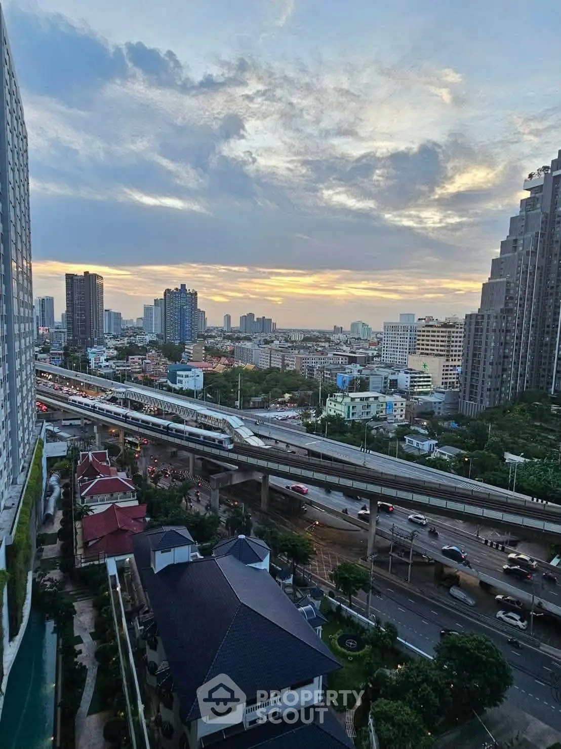 Stunning cityscape view from high-rise building at sunset, showcasing urban skyline and vibrant city life.