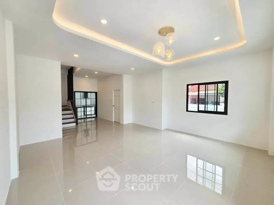 Spacious modern living room with glossy tiled floors and elegant lighting