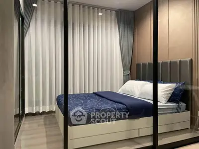 Modern bedroom with elegant decor and floor-to-ceiling curtains, featuring a stylish bed and sleek glass walls.