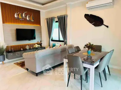 Stylish living room with modern decor and dining area, featuring elegant furniture and wall art.