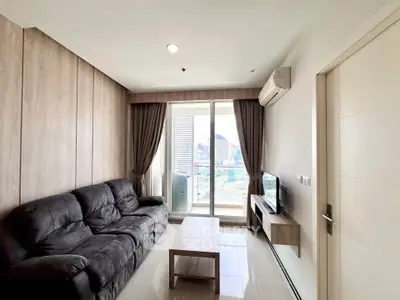 Modern living room with city view, cozy sofa, and sleek design.