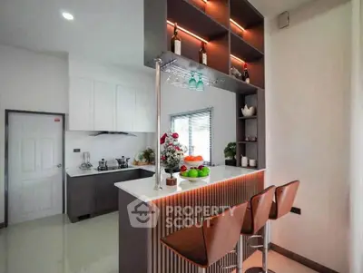 Modern kitchen with stylish bar seating and elegant lighting
